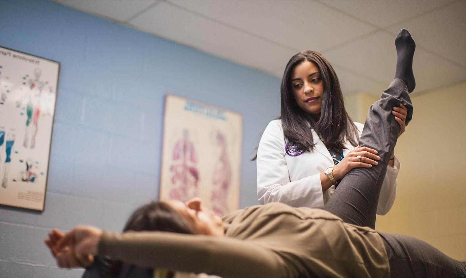 A UB Chiropractic student working on a patient